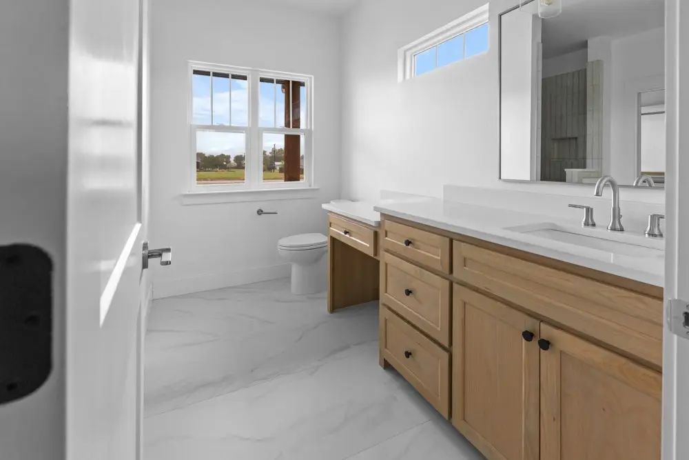 Bathroom finished in marble tile, The Dahl House, a custom home in Sherman, Texas