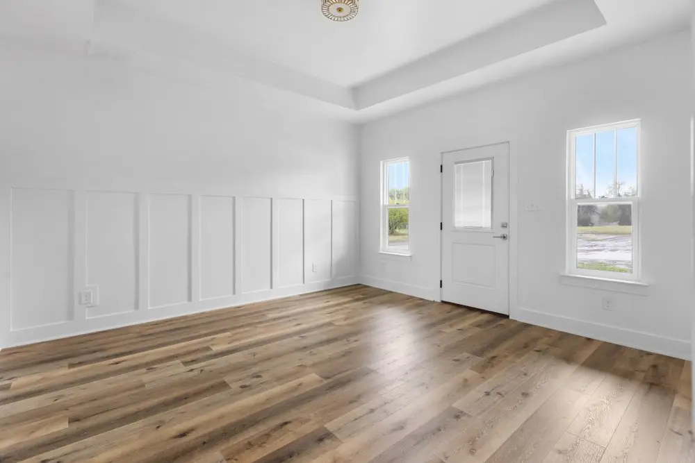 Bedroom with wainscoting and a tray ceiling, The Dahl House, a custom home in Sherman, Texas