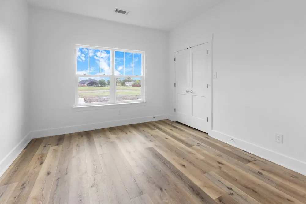 Unfurnished bedroom with a window to the yard, The Dahl House, a custom home in Sherman, Texas