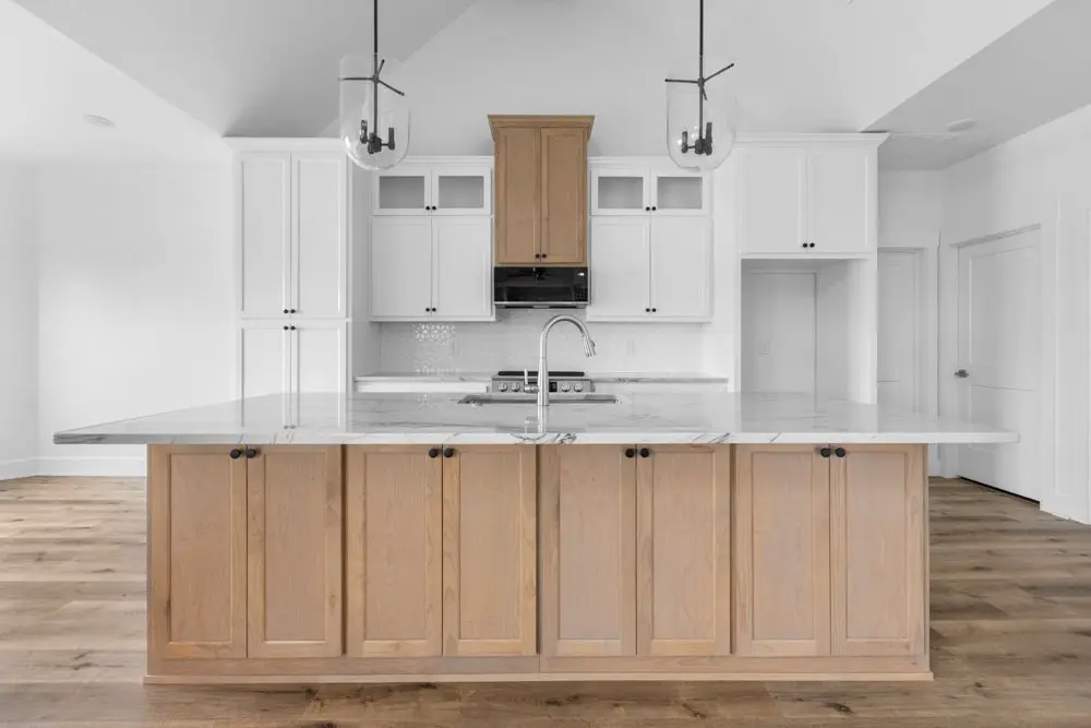 Wide view of the kitchen island and pendant lights, The Dahl House, a custom home in Sherman, Texas