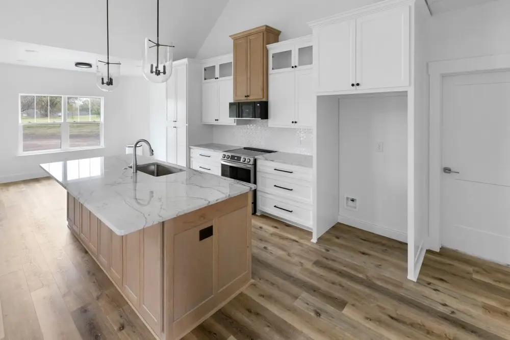 Kitchen island beside the range, The Dahl House, a custom home in Sherman, Texas