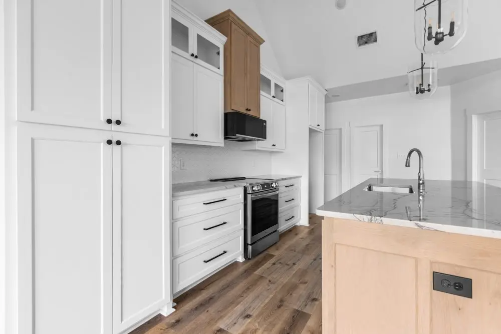 Kitchen with the range, island and pendant lights, The Dahl House, a custom home in Sherman, Texas