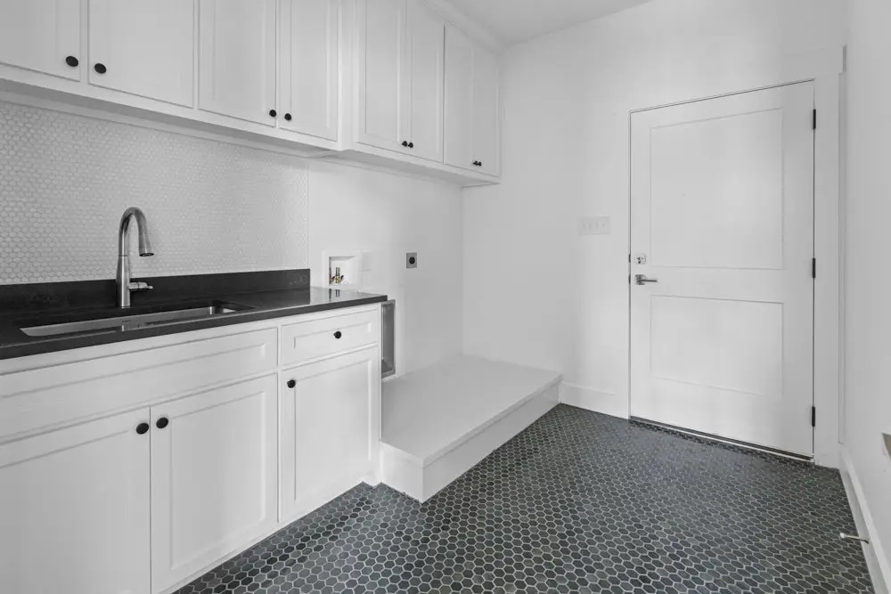 Laundry room with a black hex tile floor, The Dahl House, a custom home in Sherman, Texas