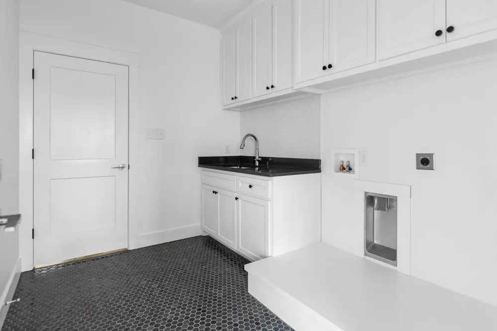 Laundry room with a sink and hex tile floor, The Dahl House, a custom home in Sherman, Texas