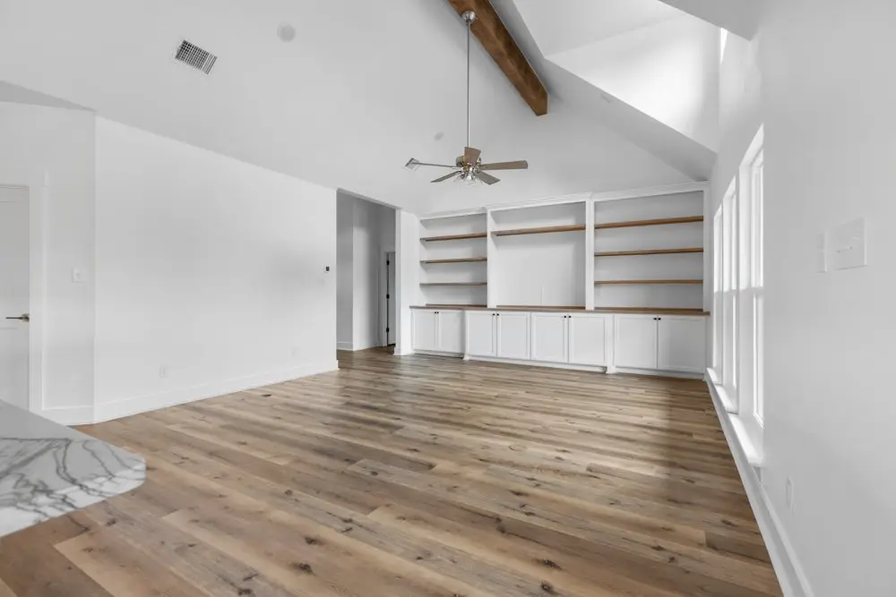 Living room built-ins under an exposed beam, The Dahl House, a custom home in Sherman, Texas