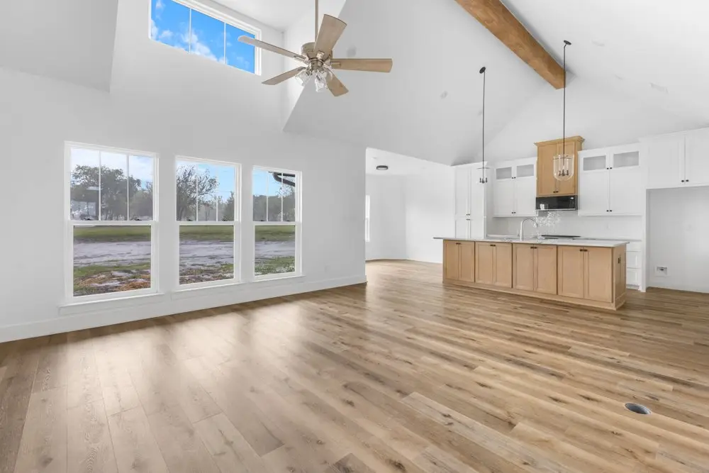 Living room through to the kitchen under a cathedral ceiling, The Dahl House, a custom home in Sherman, Texas