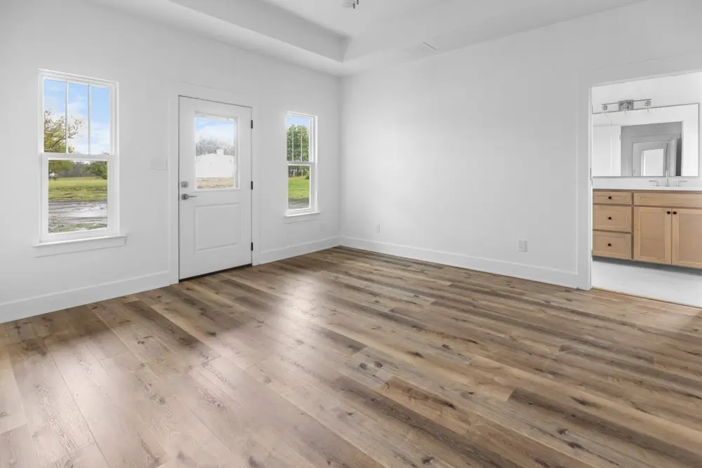 Unfurnished living room with windows to the yard, The Dahl House, a custom home in Sherman, Texas