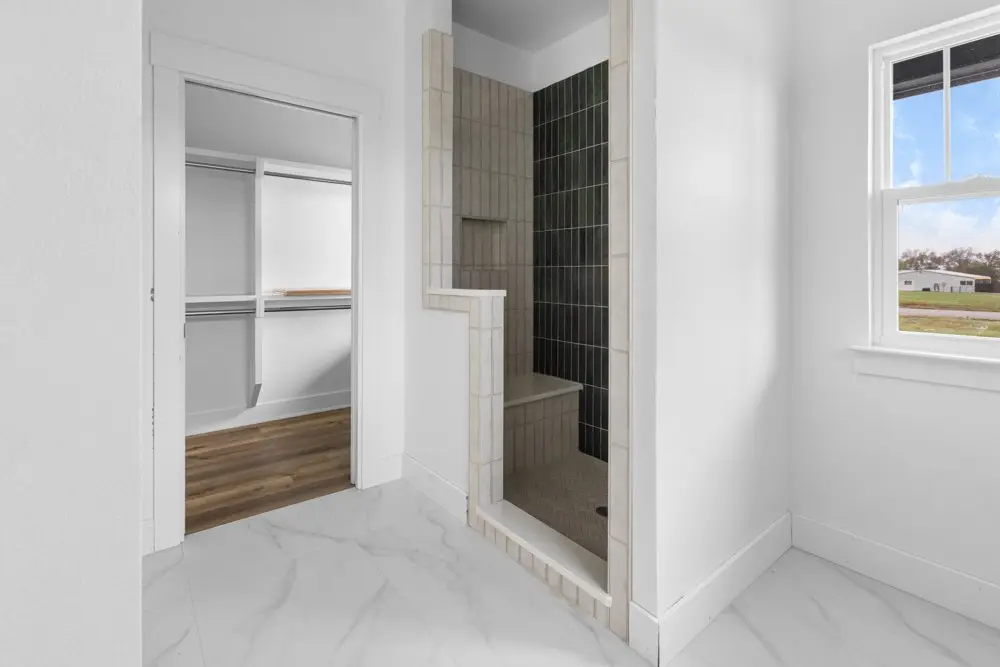 Walk-in closet beside the tiled shower, The Dahl House, a custom home in Sherman, Texas