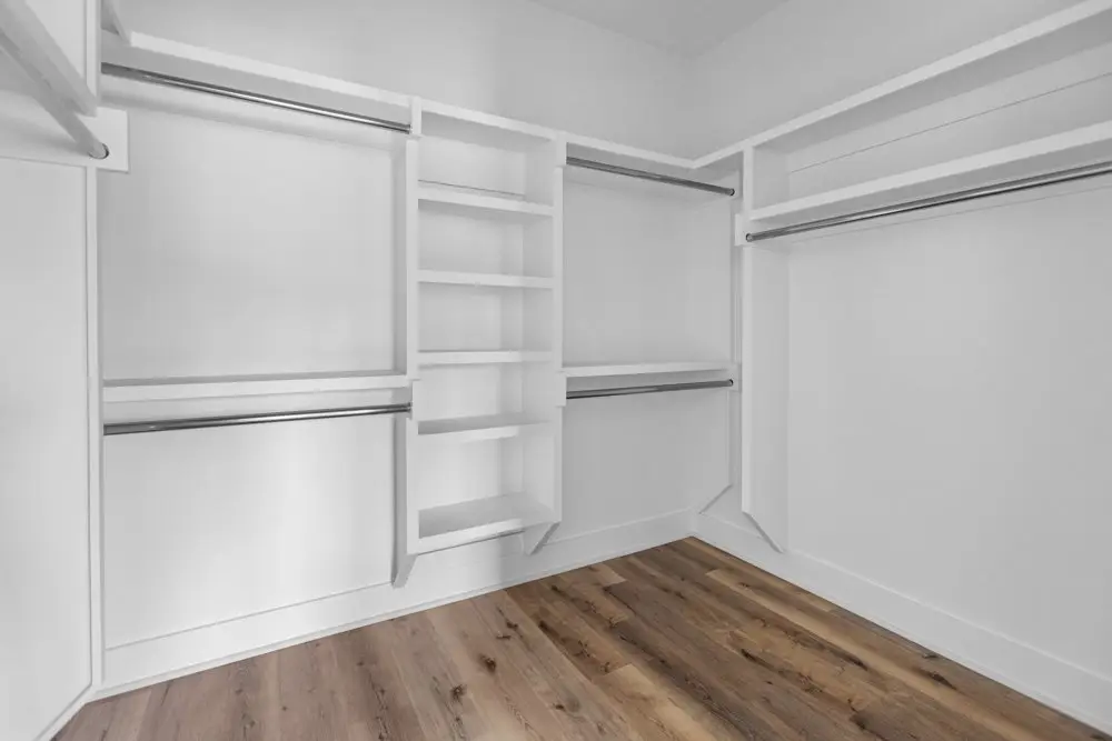 Walk-in closet with shelving and hanging rails, The Dahl House, a custom home in Sherman, Texas