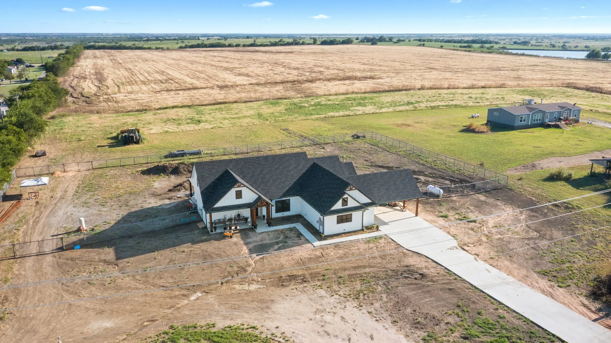 Aerial view of the house on open acreage, The Lugo House, a custom home in Sherman, Texas