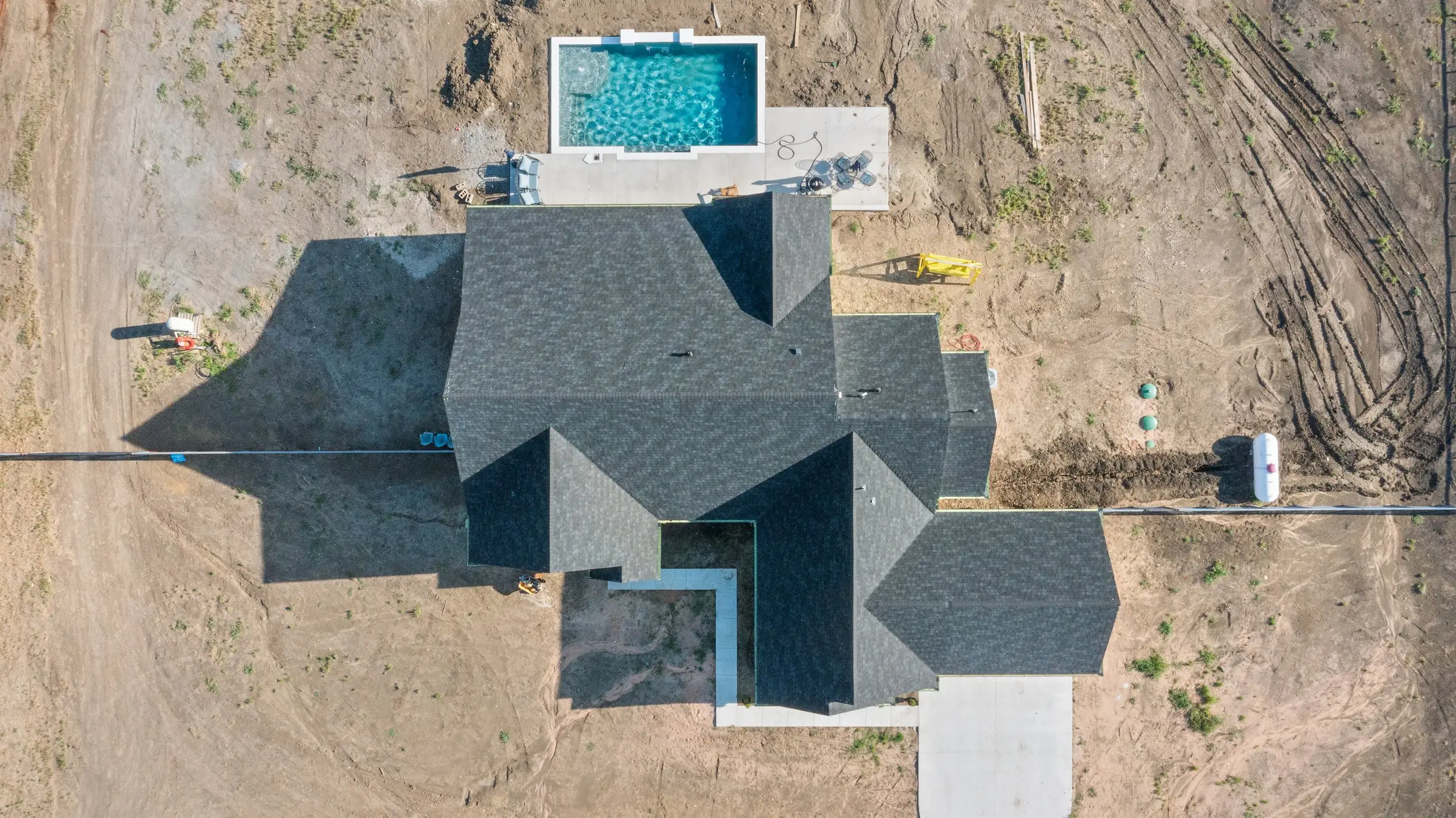 Overhead aerial view of the roof and pool, The Lugo House, a custom home in Sherman, Texas