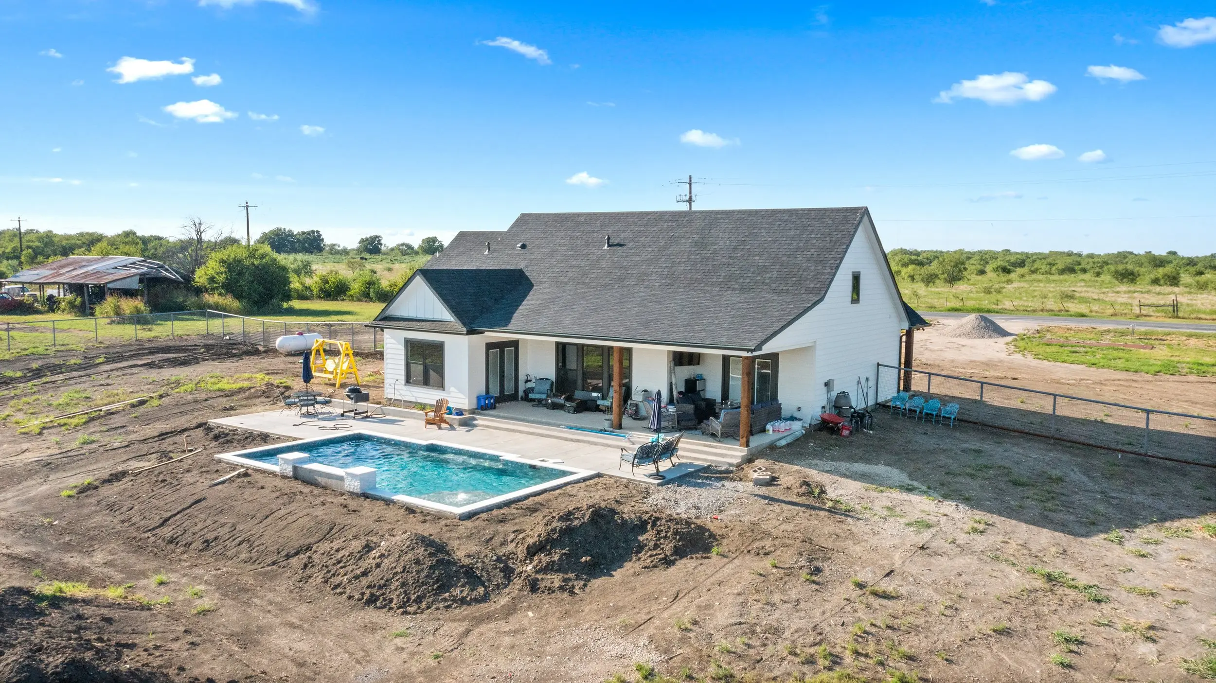 Aerial view of the rear of the house with the pool, The Lugo House, a custom home in Sherman, Texas