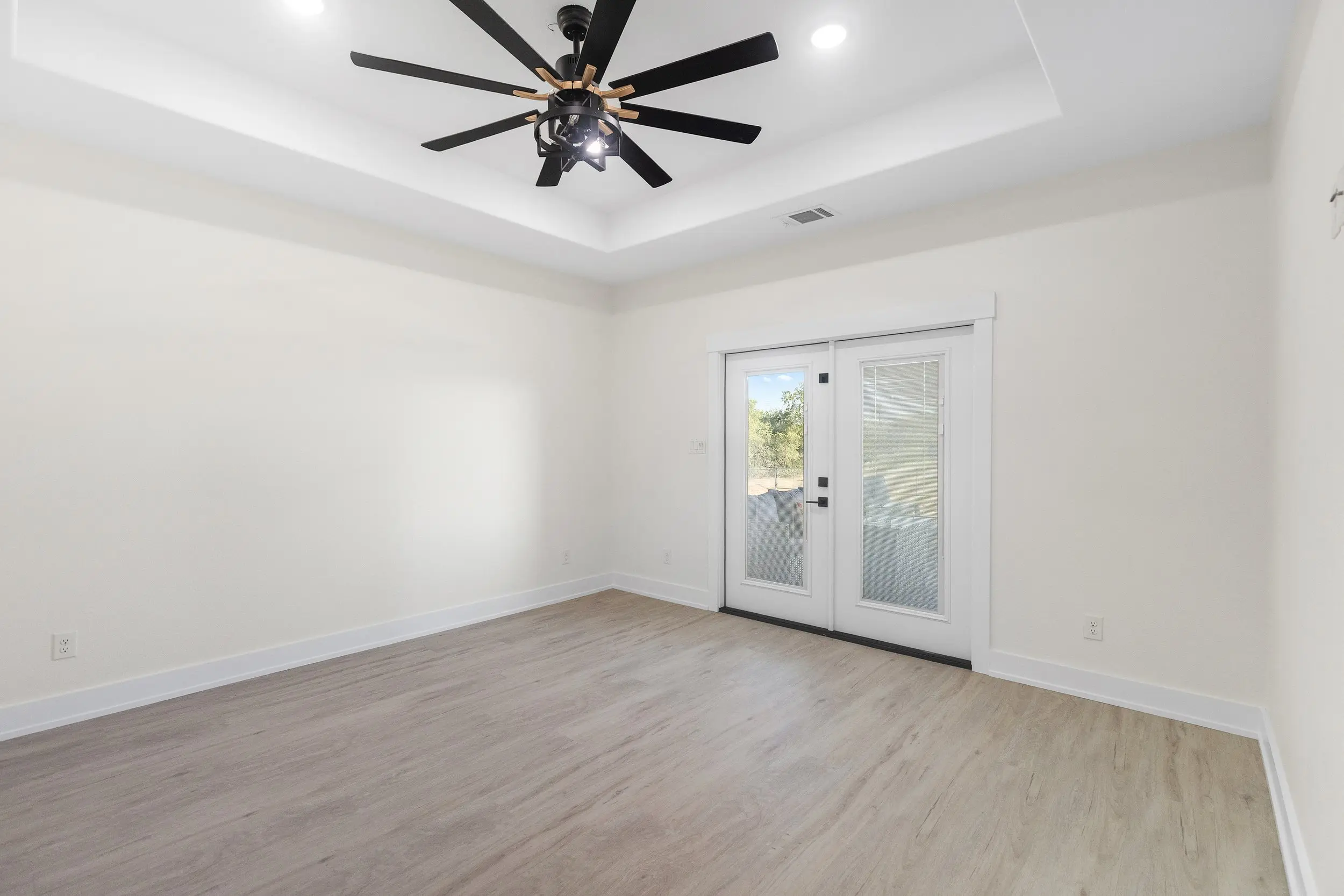 Bedroom with French doors to the outside, The Lugo House, a custom home in Sherman, Texas