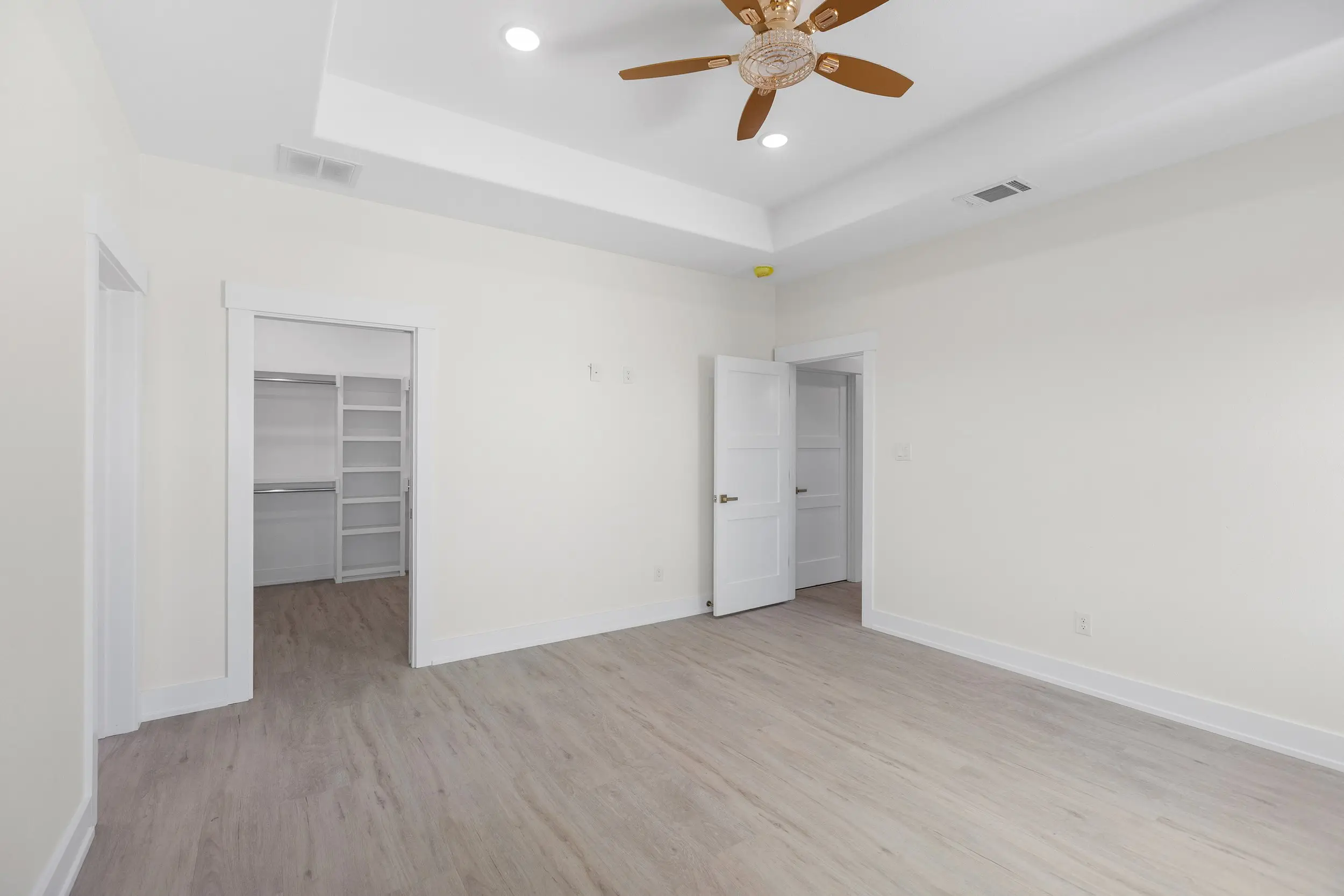 Bedroom with a tray ceiling and closet, The Lugo House, a custom home in Sherman, Texas