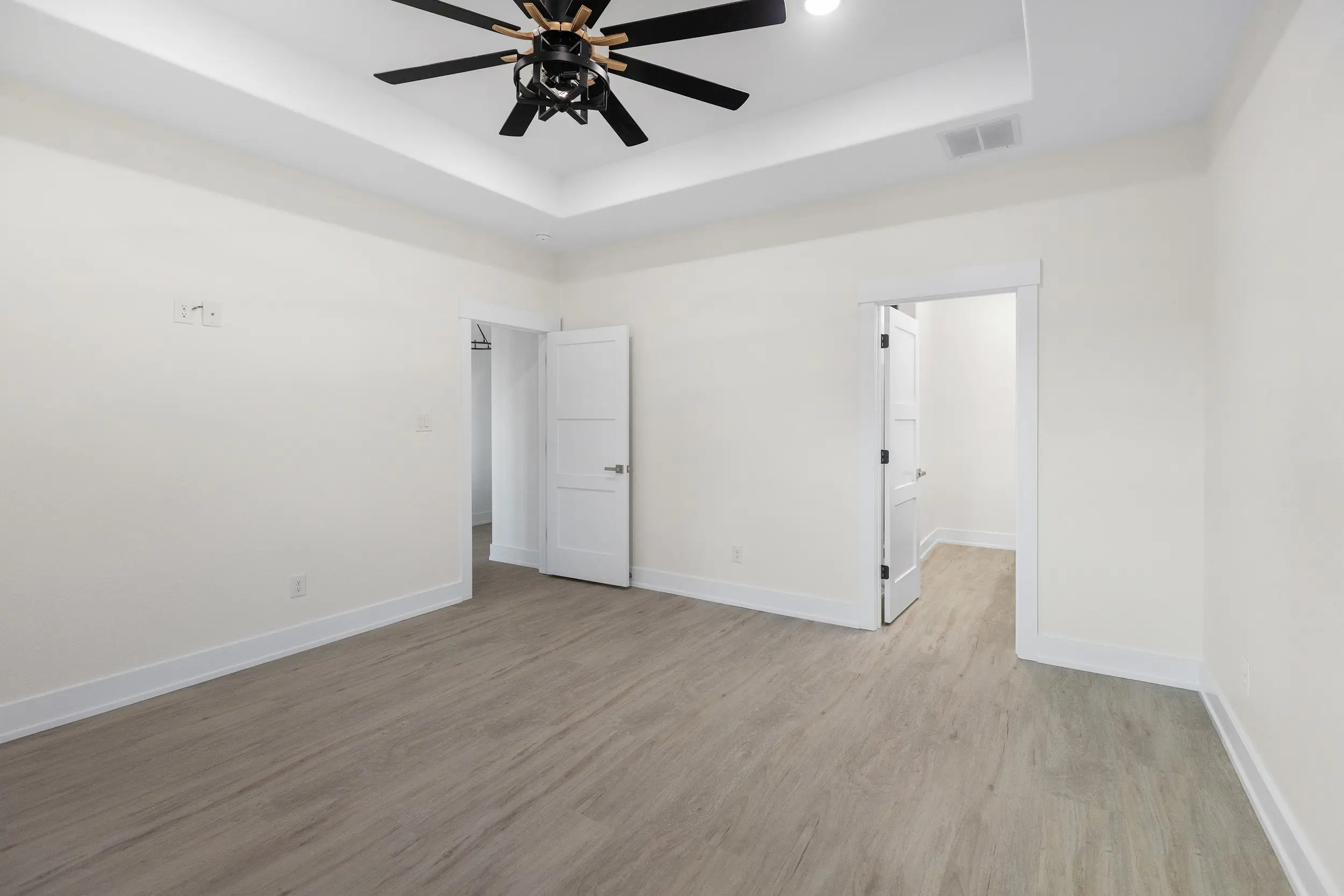 Bedroom with a tray ceiling, The Lugo House, a custom home in Sherman, Texas