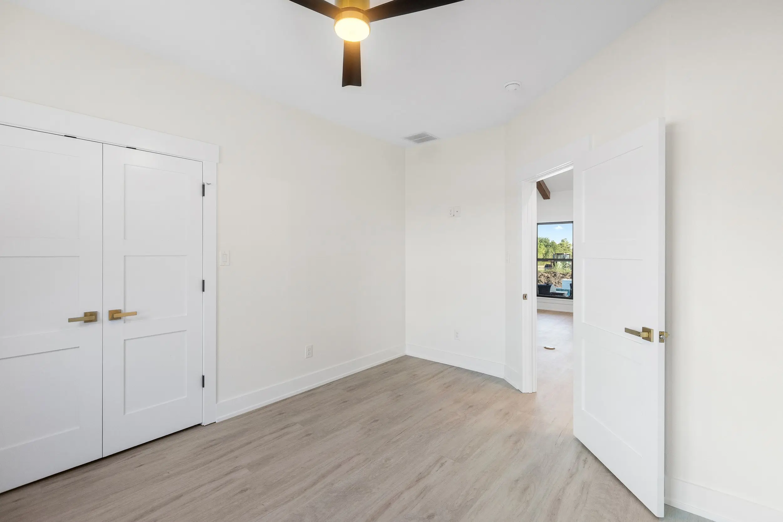 Hallway with double closet doors, The Lugo House, a custom home in Sherman, Texas