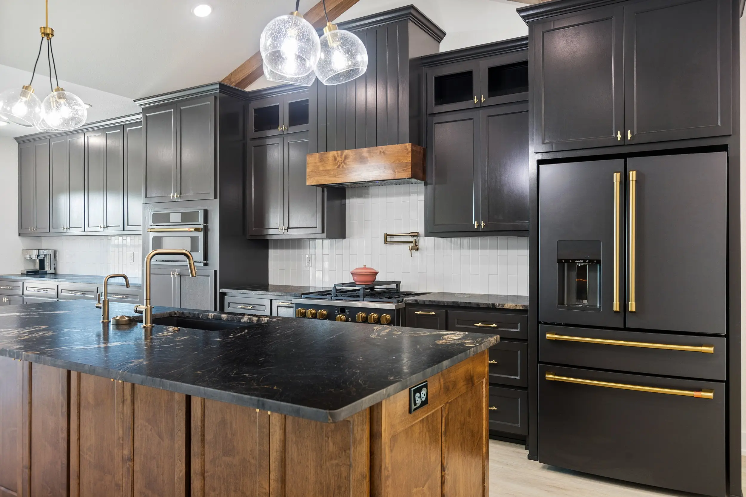 Kitchen with black appliances and gold hardware, The Lugo House, a custom home in Sherman, Texas