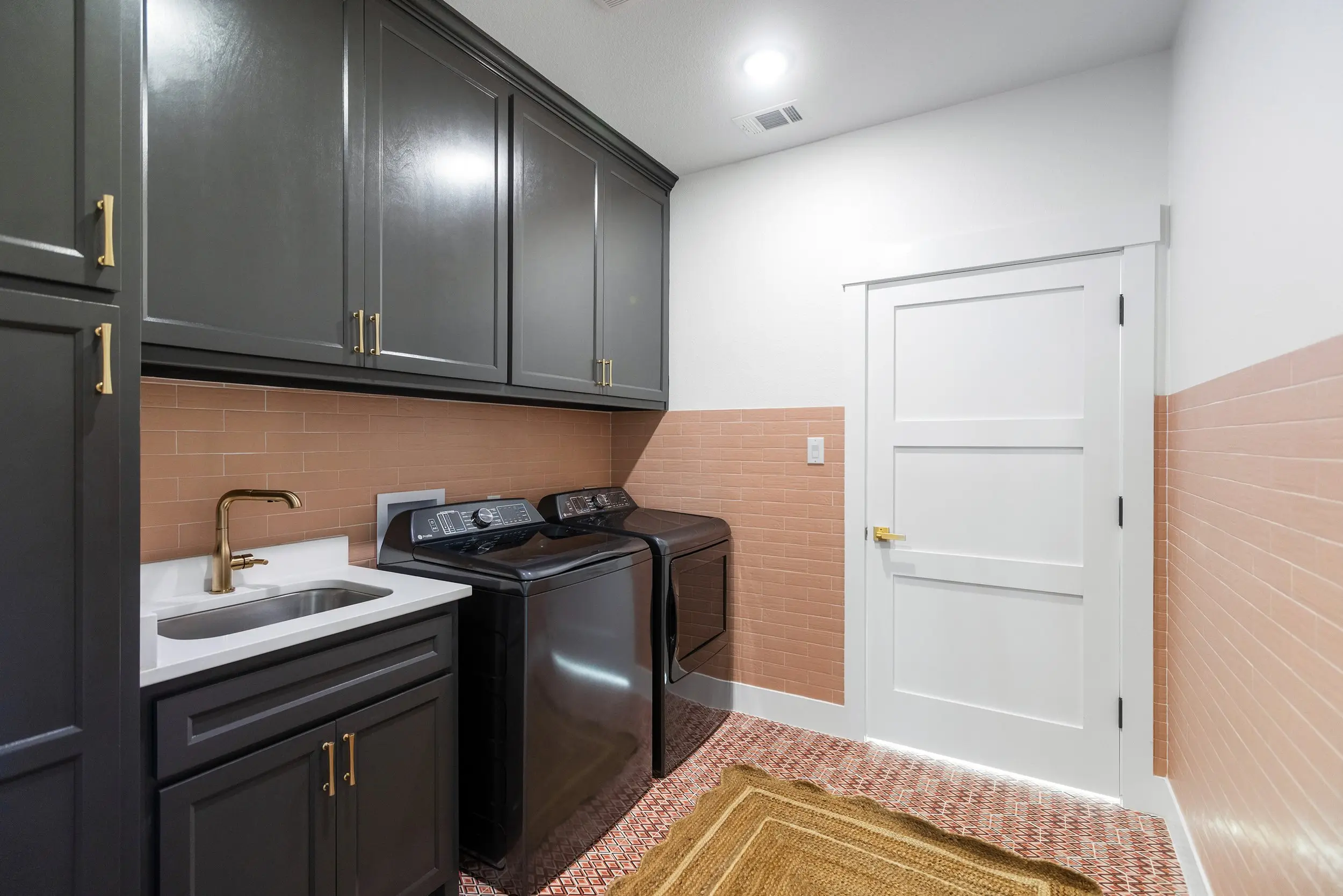 Laundry room with washer and dryer in place, The Lugo House, a custom home in Sherman, Texas
