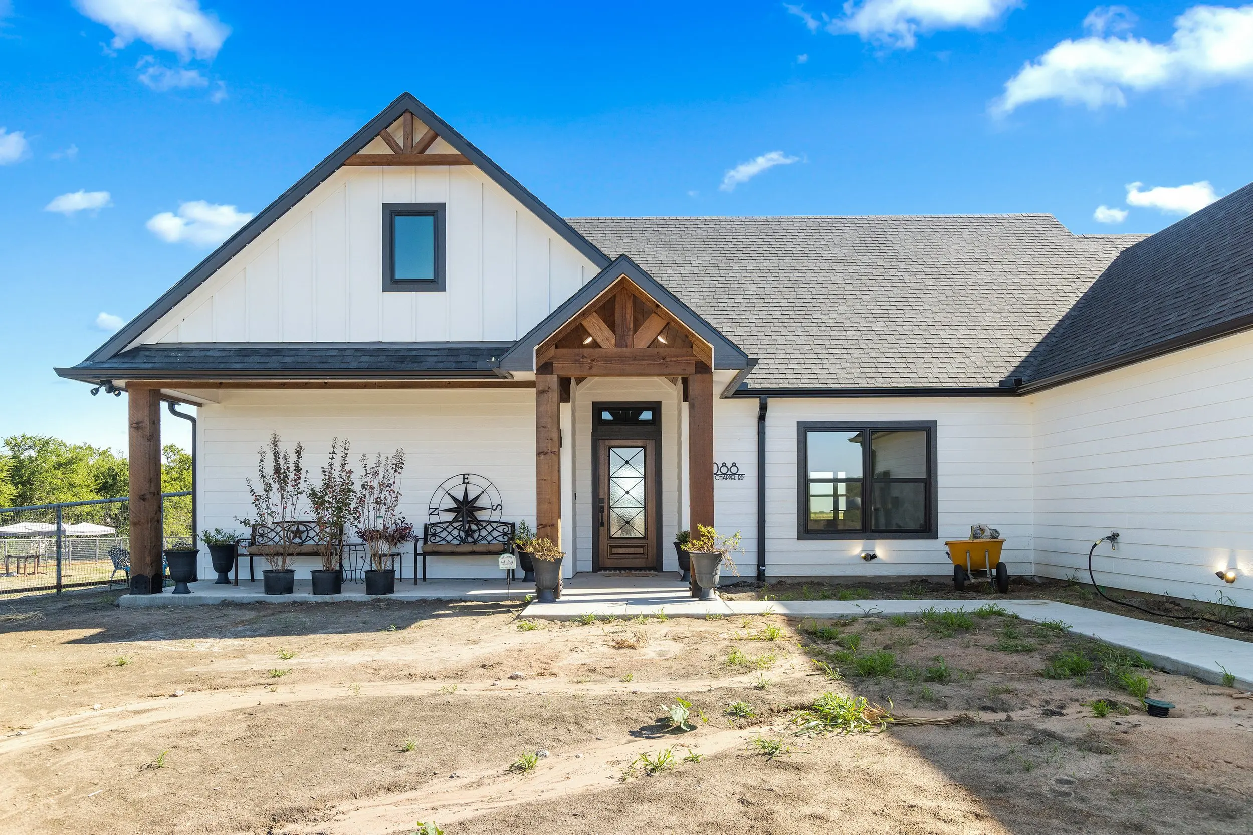 The Lugo House, a white modern farmhouse on open acreage near Sherman.