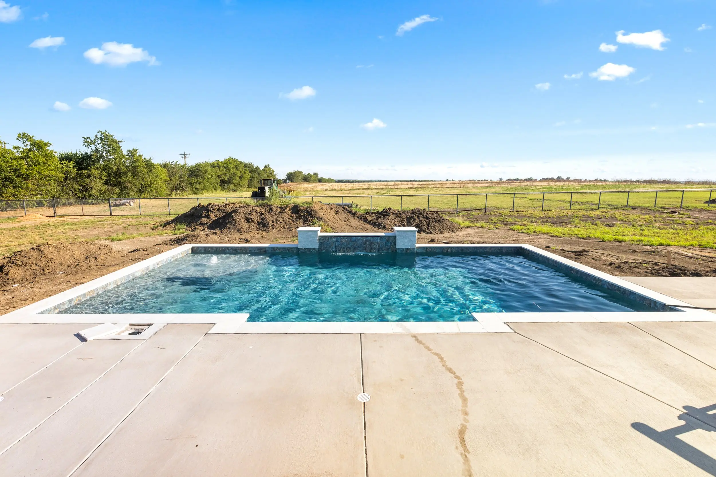 Swimming pool looking out over open field, The Lugo House, a custom home in Sherman, Texas