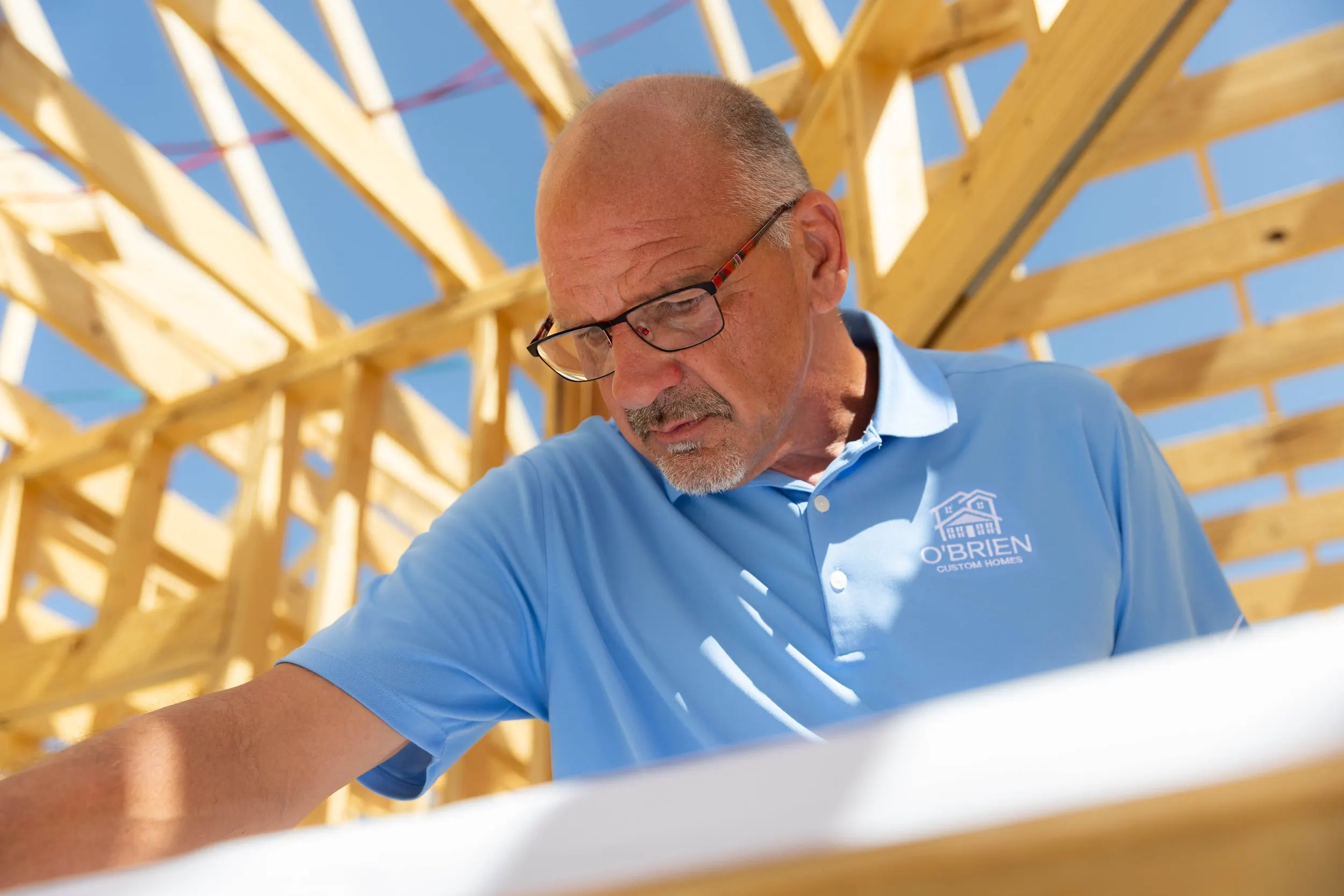 Randy O'Brien reviewing house plans on a build site in Grayson County, Texas
