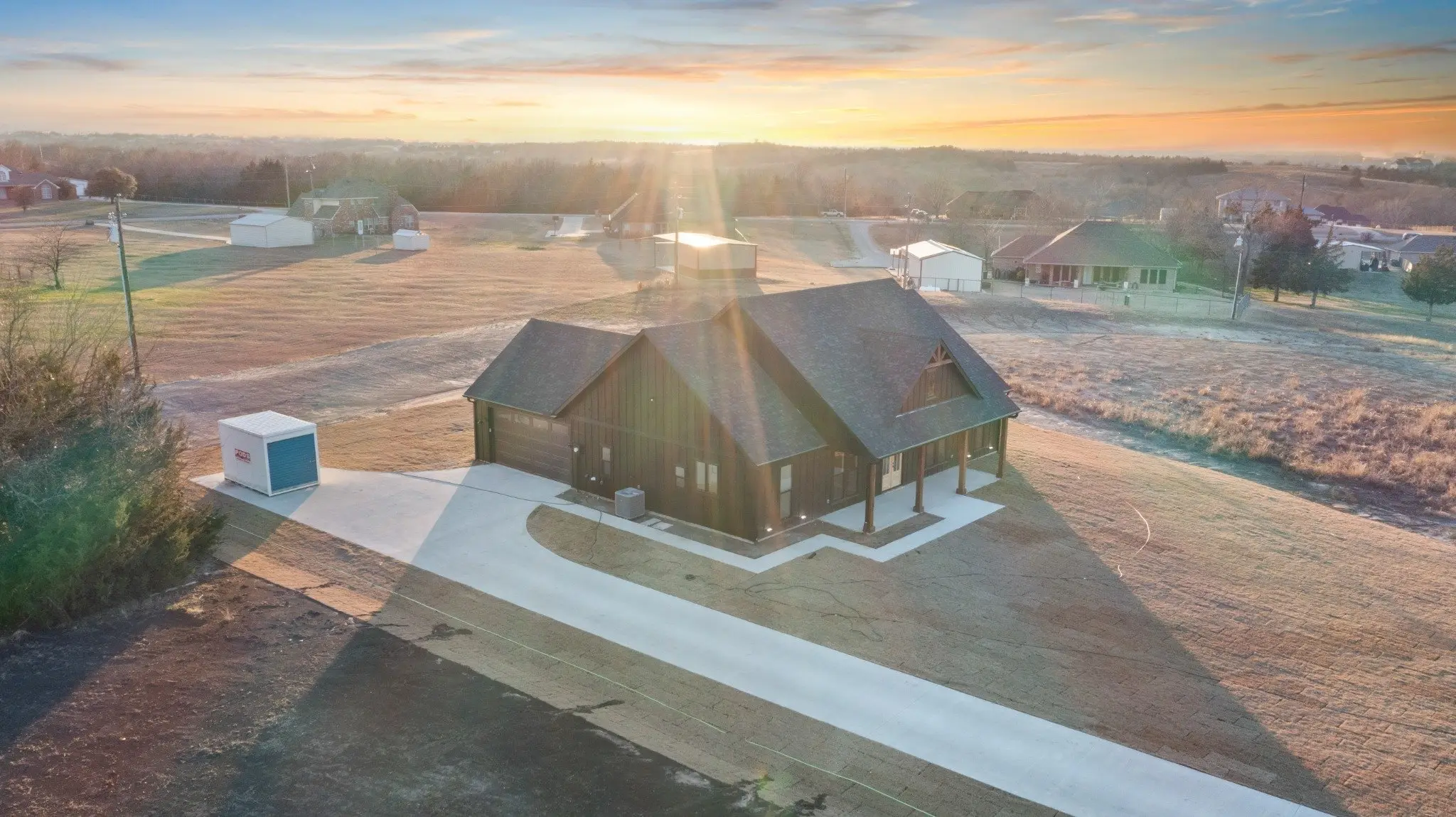 Aerial view across the property at sunset, The Wester House, a custom home in Sherman, Texas