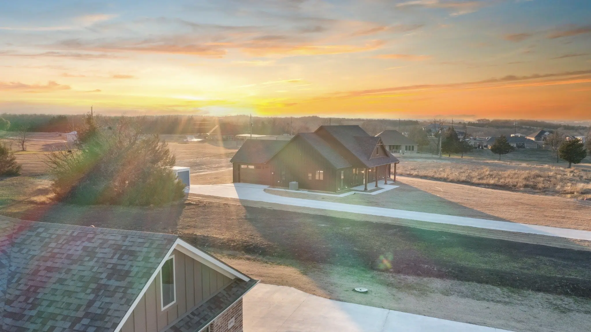 Aerial view over the roofline at sunset, The Wester House, a custom home in Sherman, Texas