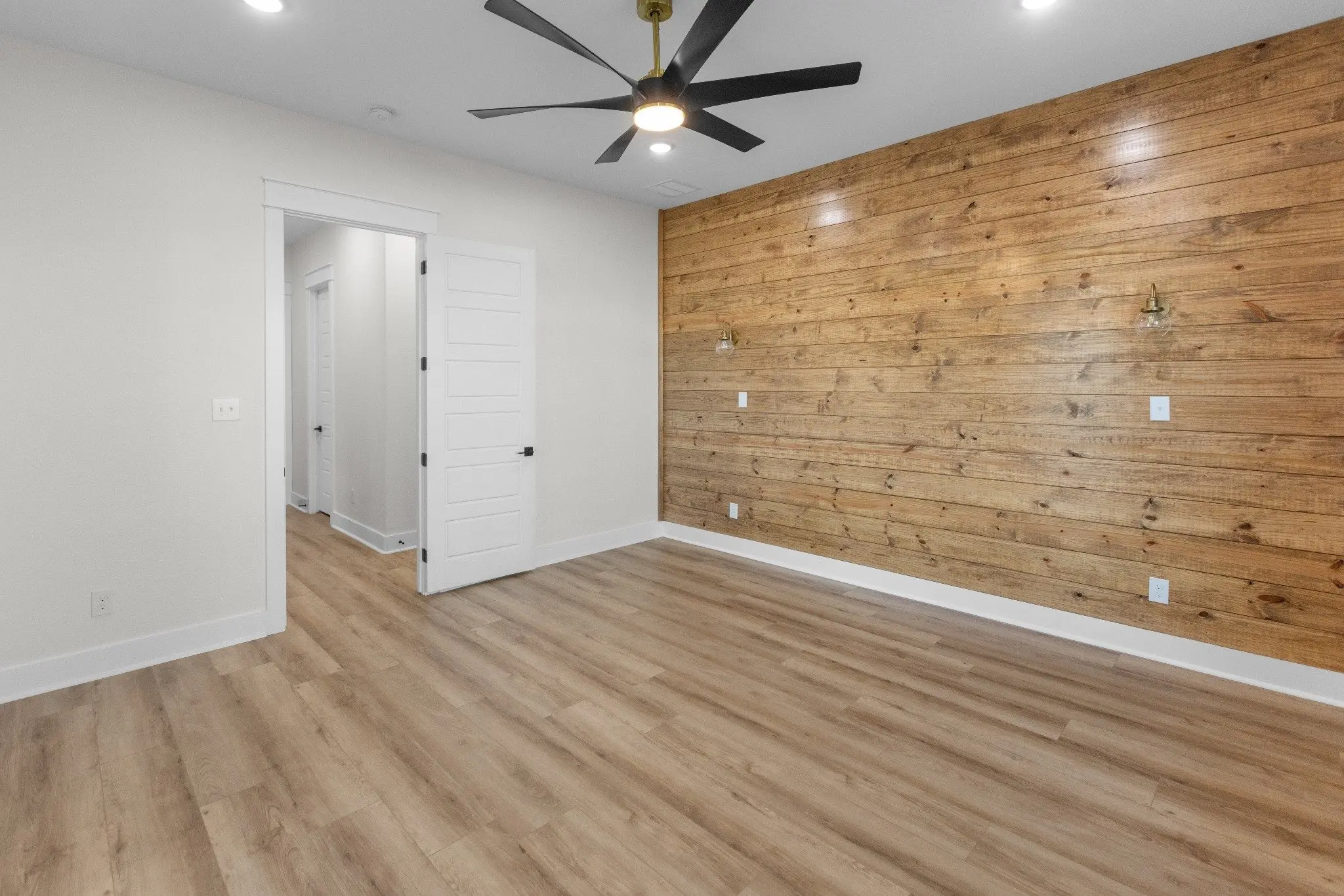 Unfurnished bedroom with a cedar accent wall, The Wester House, a custom home in Sherman, Texas