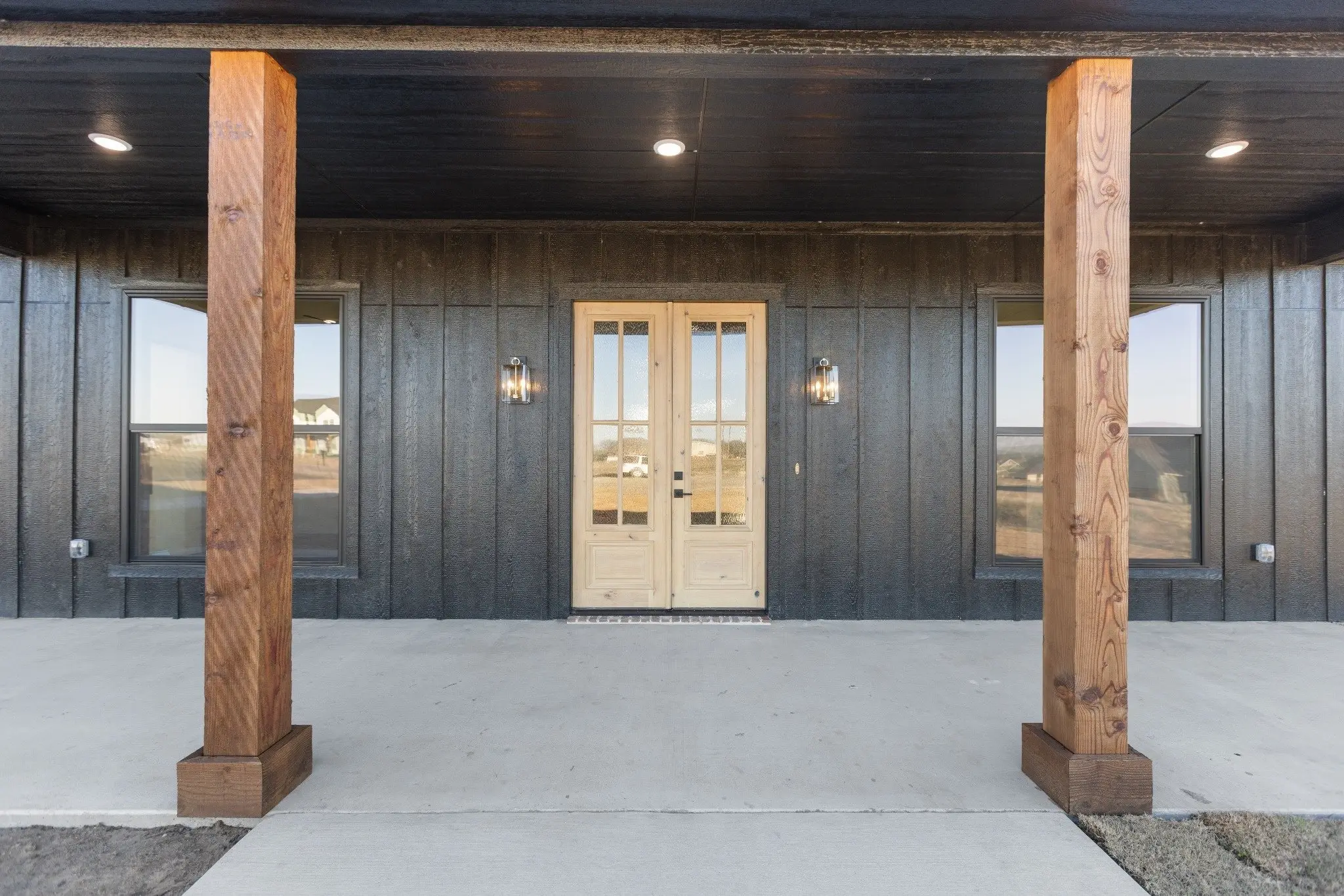 Covered back porch on cedar posts with French doors, The Wester House, a custom home in Sherman, Texas