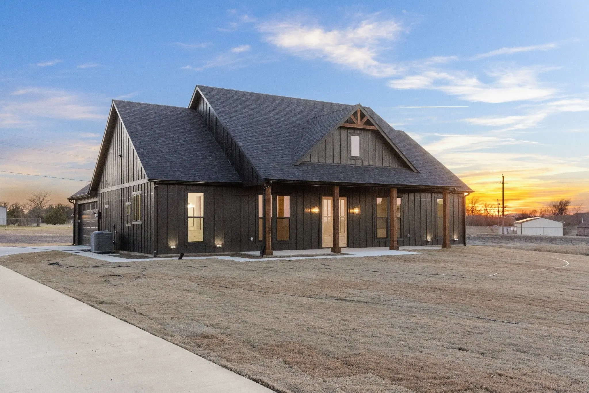 Wide view of the front elevation at dusk, The Wester House, a custom home in Sherman, Texas