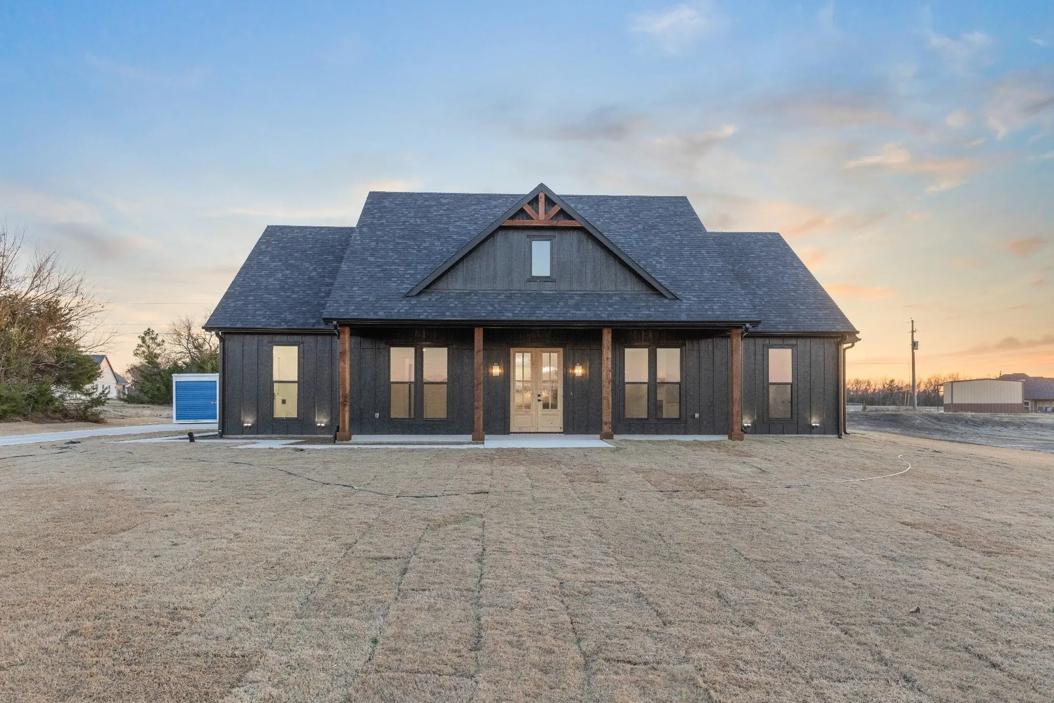 Front elevation lit from inside at dusk, The Wester House, a custom home in Sherman, Texas