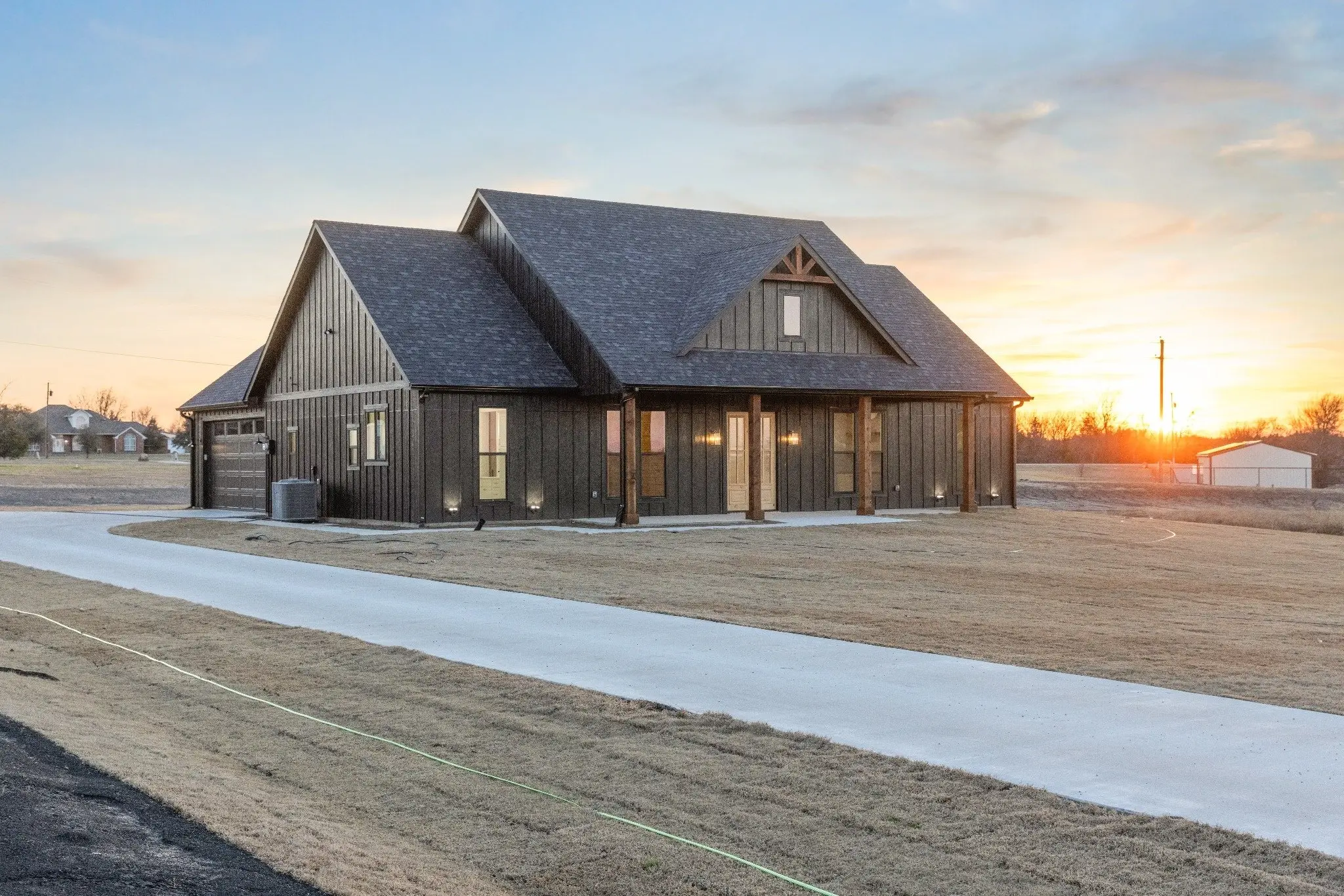 Wide view of the front of the house at sunset, The Wester House, a custom home in Sherman, Texas
