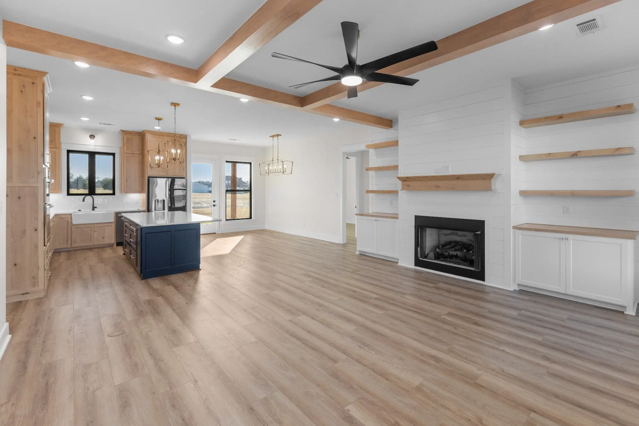 Great room with a fireplace, open to the kitchen, The Wester House, a custom home in Sherman, Texas