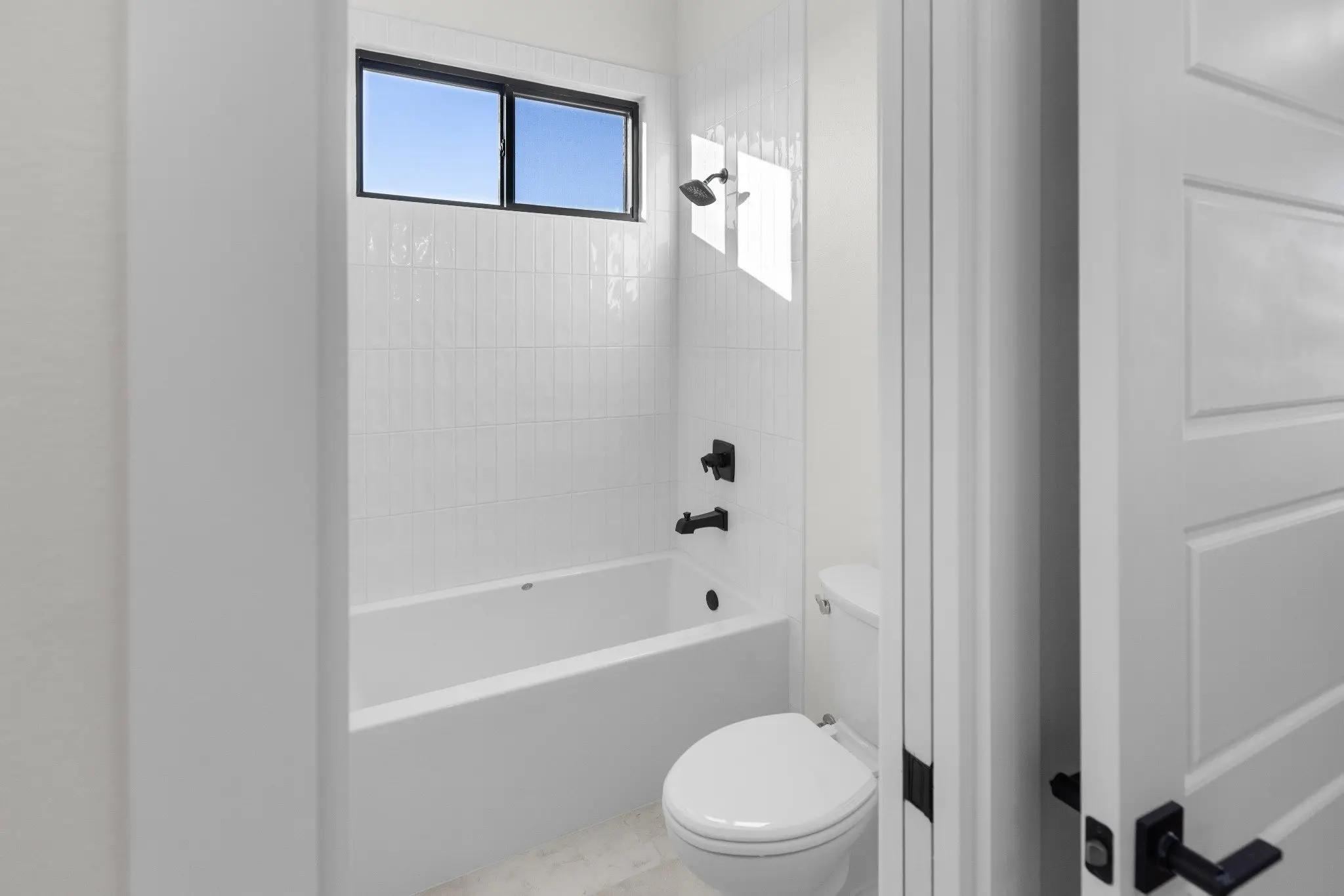 Guest bathroom with a tub and shower combination, The Wester House, a custom home in Sherman, Texas