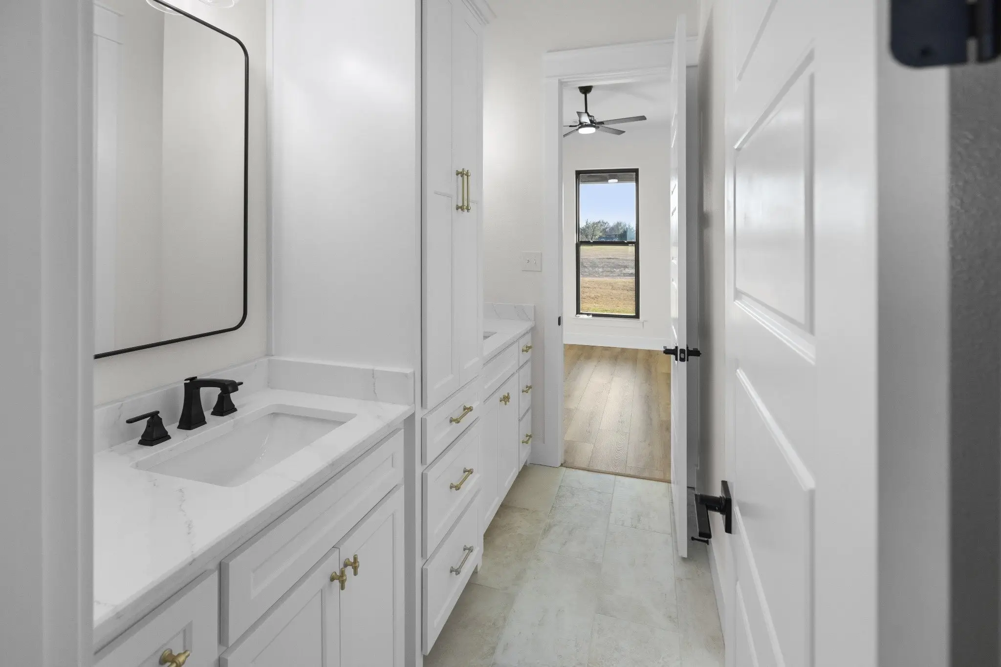 Guest bathroom vanity looking through to the hall, The Wester House, a custom home in Sherman, Texas