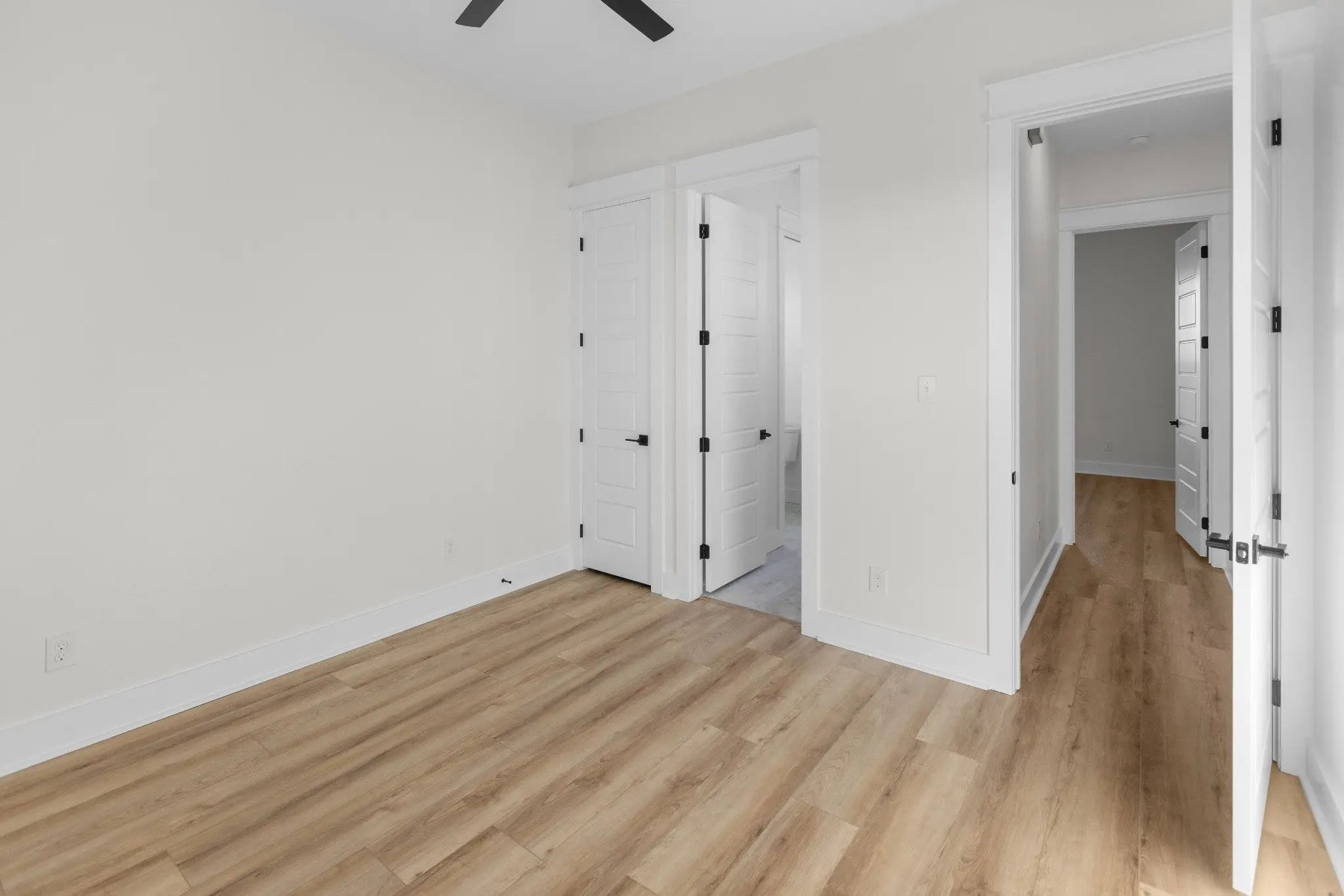 Hallway with bedroom doors, The Wester House, a custom home in Sherman, Texas