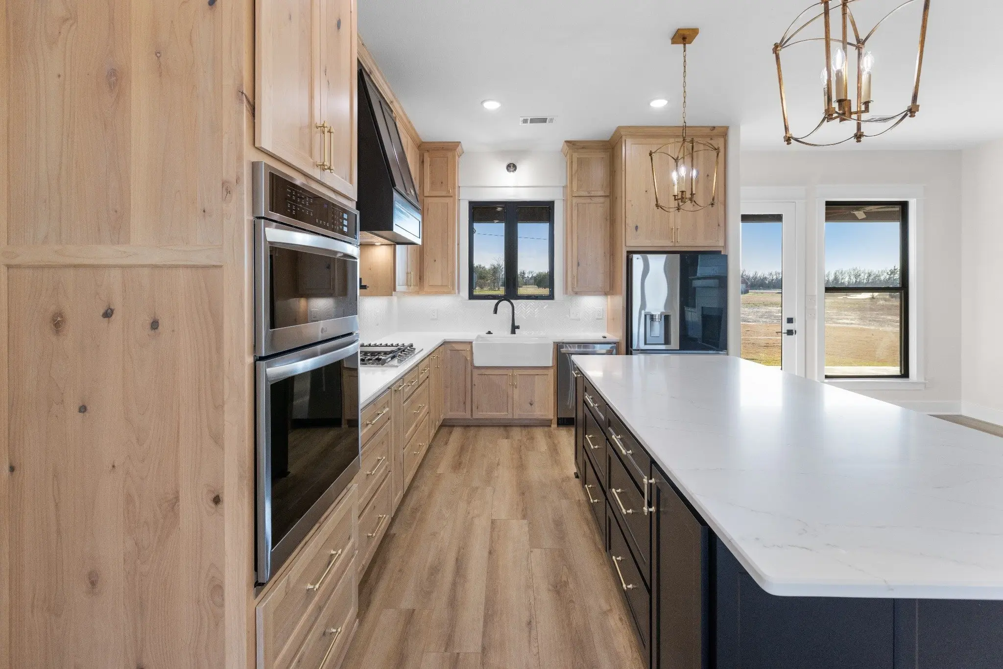 Kitchen in white oak with a long island, The Wester House, a custom home in Sherman, Texas