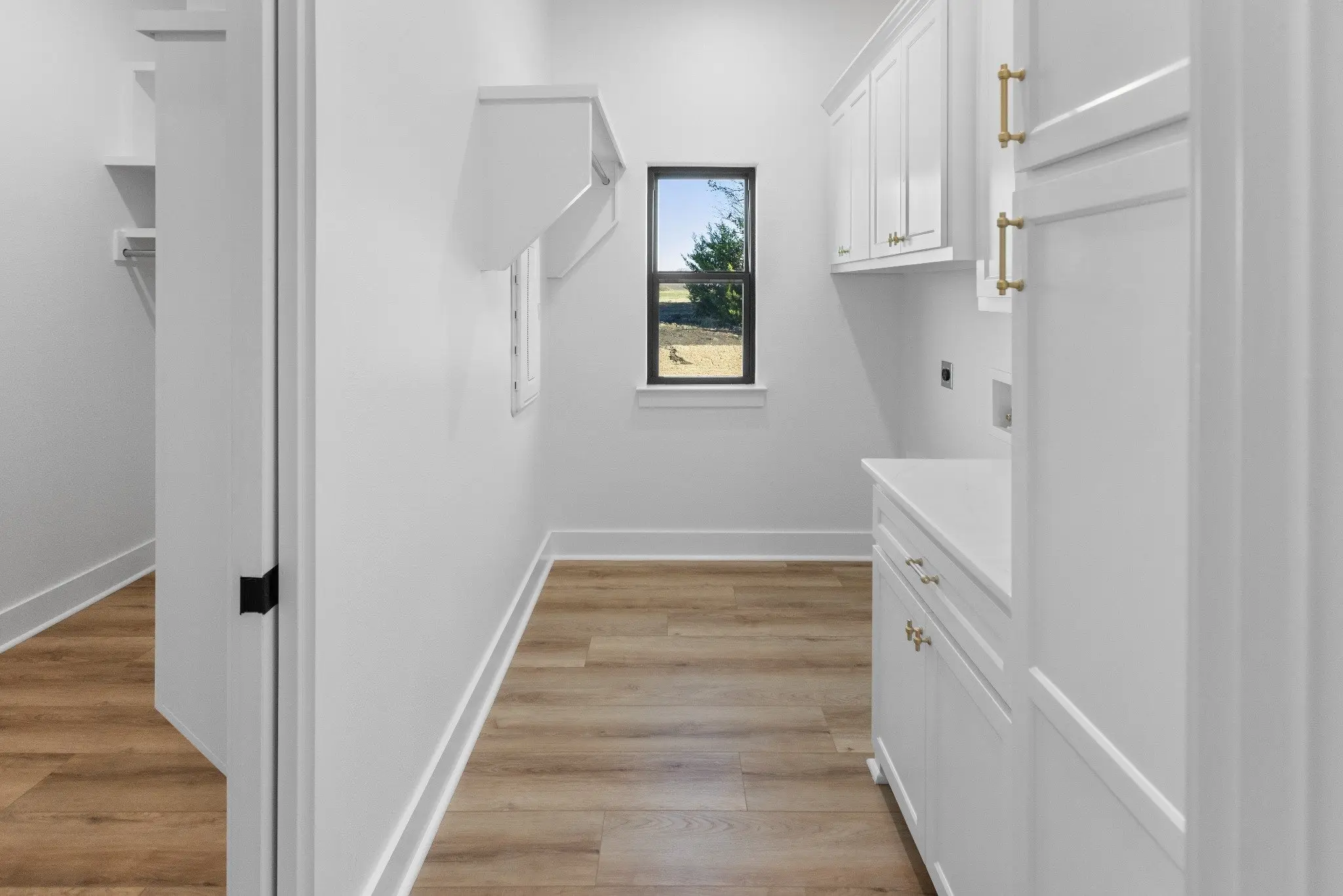 Laundry room with white cabinetry, The Wester House, a custom home in Sherman, Texas