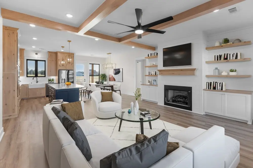 Living room with a fireplace, built-in shelving and a beamed ceiling, The Wester House, a custom home in Sherman, Texas