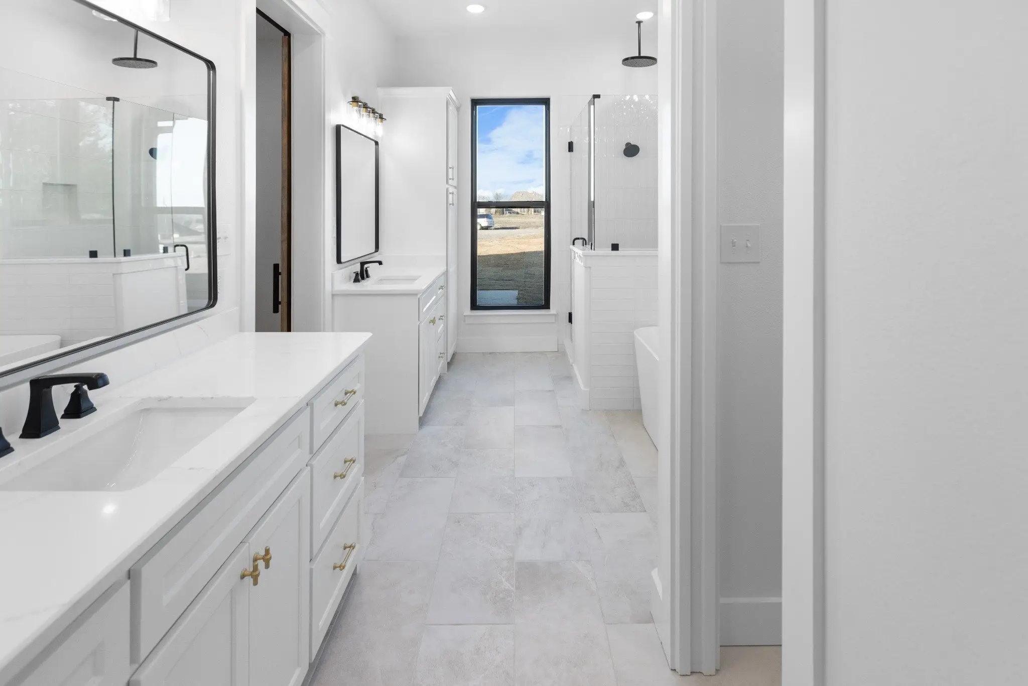 Primary bathroom with a double vanity and walk-in shower, The Wester House, a custom home in Sherman, Texas