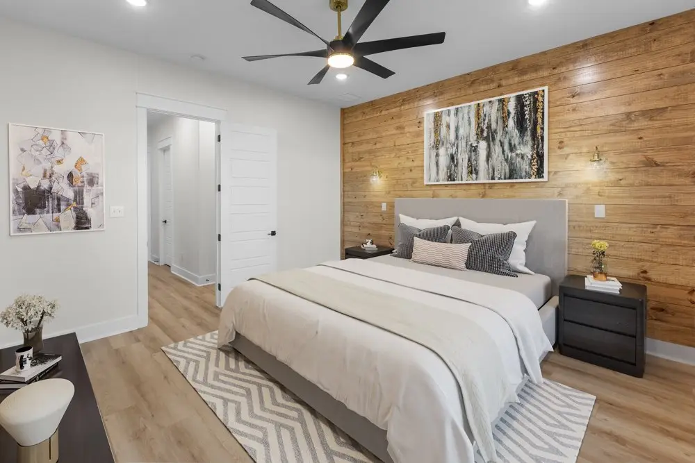 Primary bedroom, staged, against a cedar accent wall, The Wester House, a custom home in Sherman, Texas