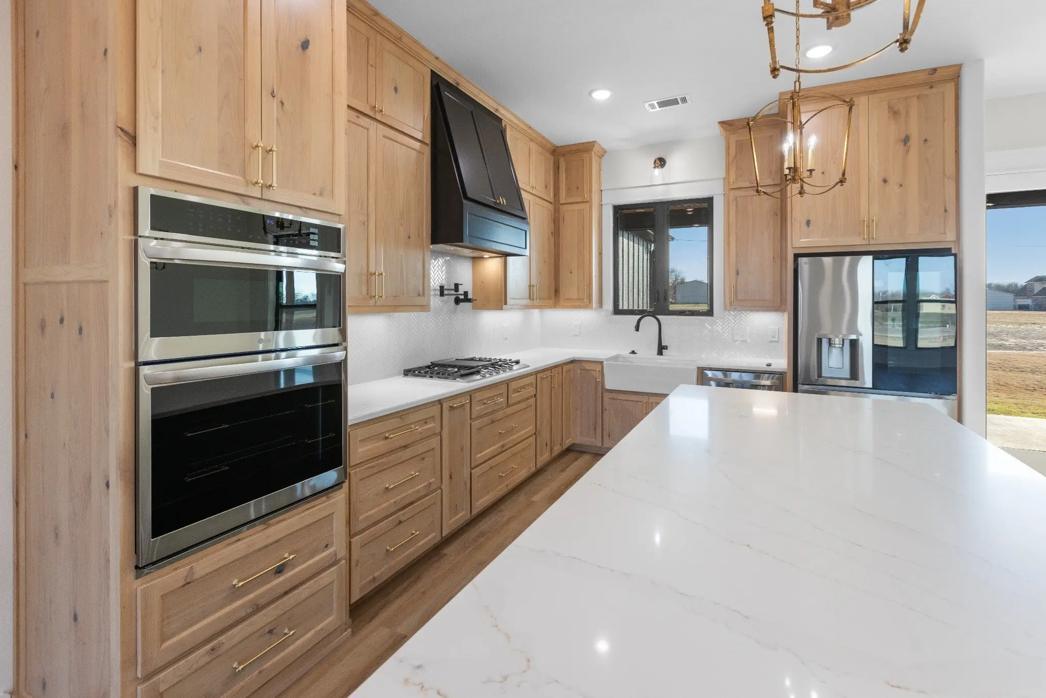 Kitchen with double ovens and a quartz island, The Wester House, a custom home in Sherman, Texas